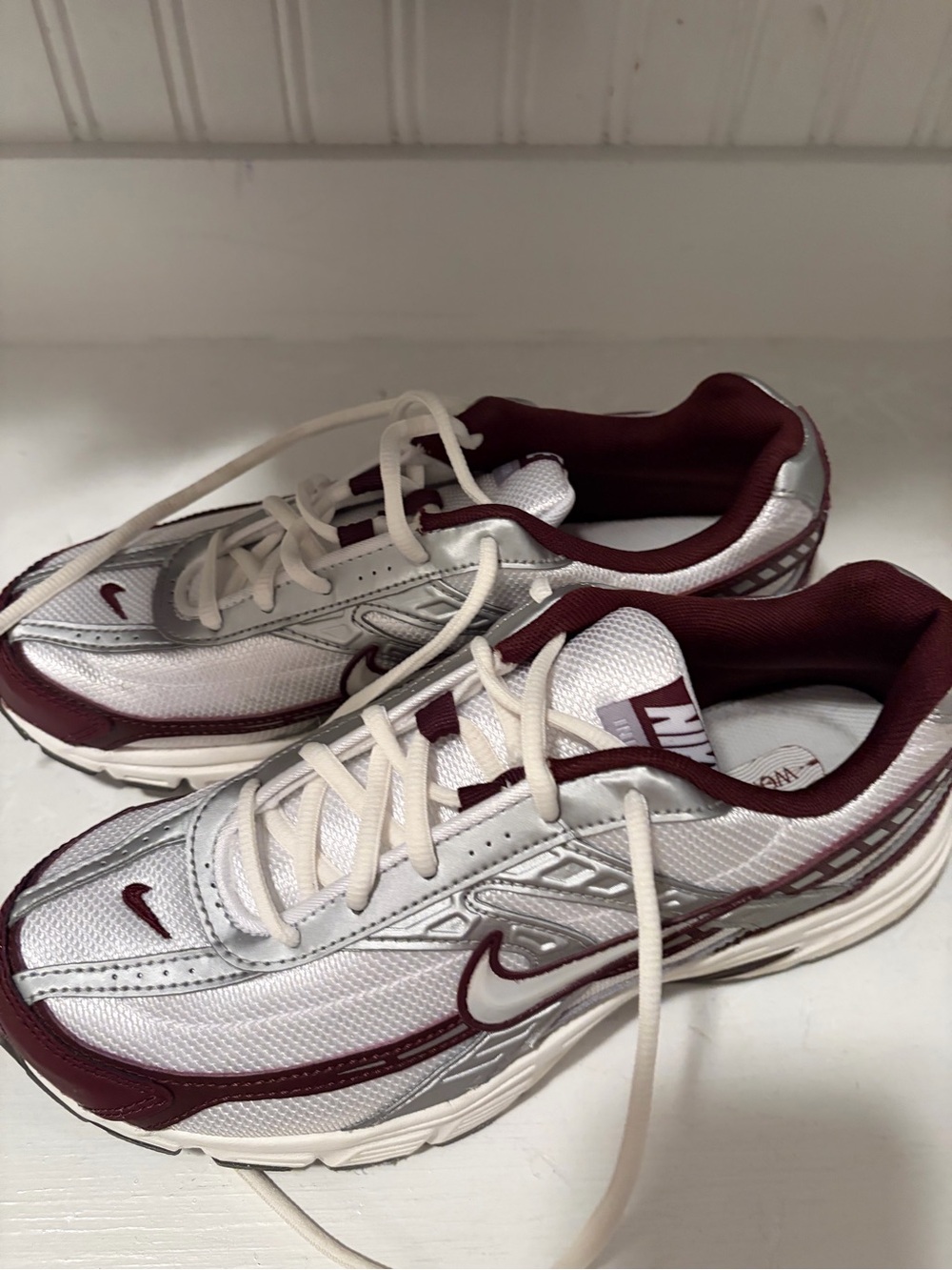 Nike woman’s white  & burgundy with silver Initiator Sneakers